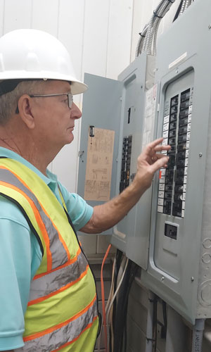 abbeville commissioning employee working on a fusebox